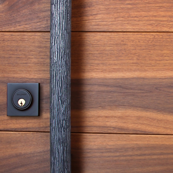 A wood entry door with a large door pull