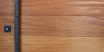mahogany wooden door with custom round hammered door pulls and black square lock