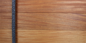 wooden entry door made of mahogany wood with round modern door handles