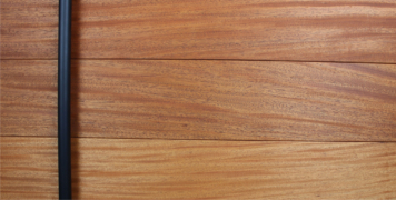 modern entrance wood door made of mahogany wood with round black stainless steel door handles