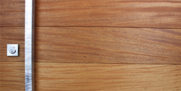mahogany wooden door behind serrated and polished modern door pulls with stainless steel door lock