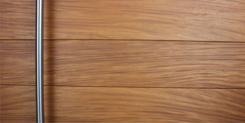 wooden front door made of teak wood and round stainless door hardware