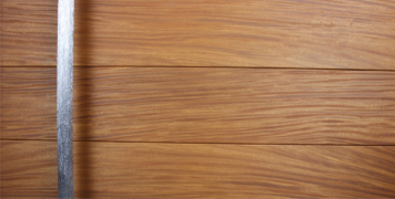wooden entry door with modern door handles made of polished steel