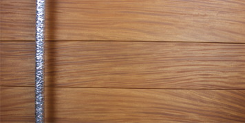 modern wood front door made of teak hardwood and round polished door hardware