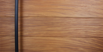 wood modern front door with round black powder-coated door pulls