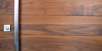 genuine walnut hardwood behind handcrafted door pulls and square stainless steel door lock