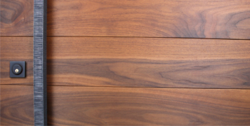 walnut hardwood behind square door hardware and black square door lock