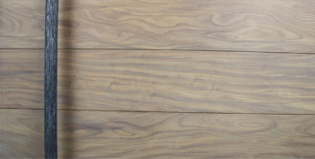 long dark modern door handles behind washed teak wooden front door
