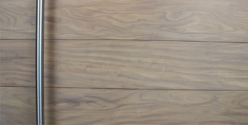 stainless steel round door handles behind washed teak hardwood front door