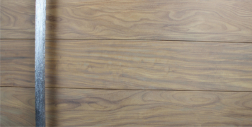 washed teak wooden exterior door with long polished custom door handle