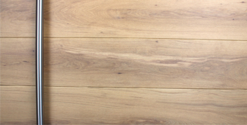 white oak wooden front door with round brushed stainless steel door handle