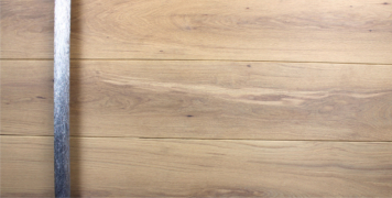 white oak hardwood exterior door behind polished custom door handles
