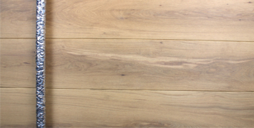luxury wooden door with polished round silver door handle made of white oak
