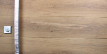 white oak hardwood door behind modern square door pulls and square stainless steel door lock